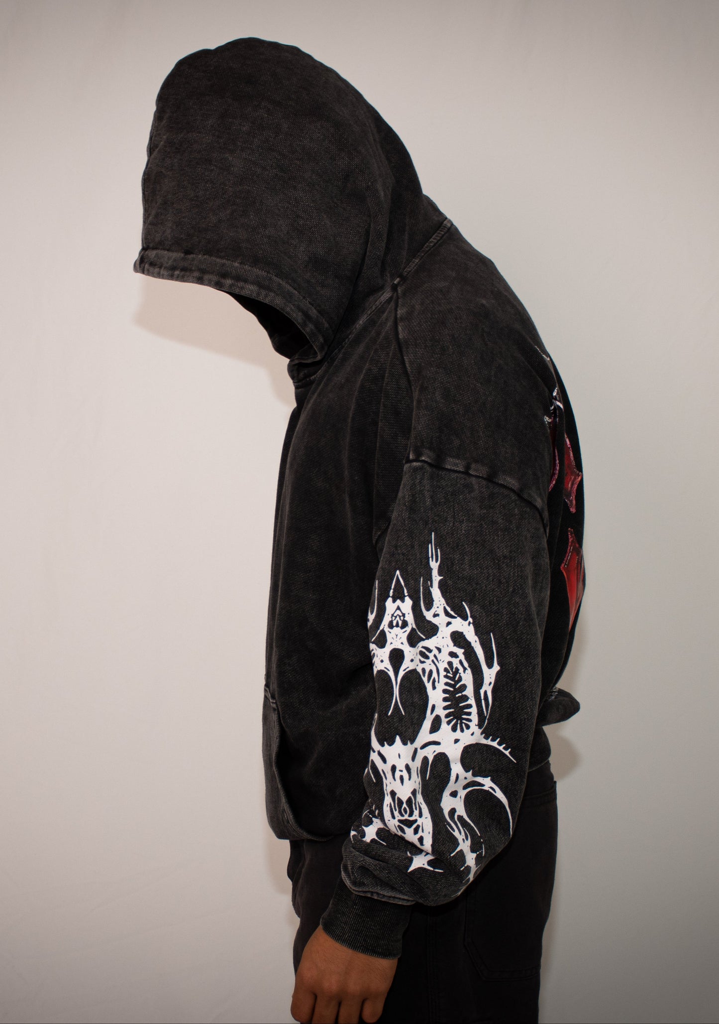 Black hoodie with white graphic design on a plain background